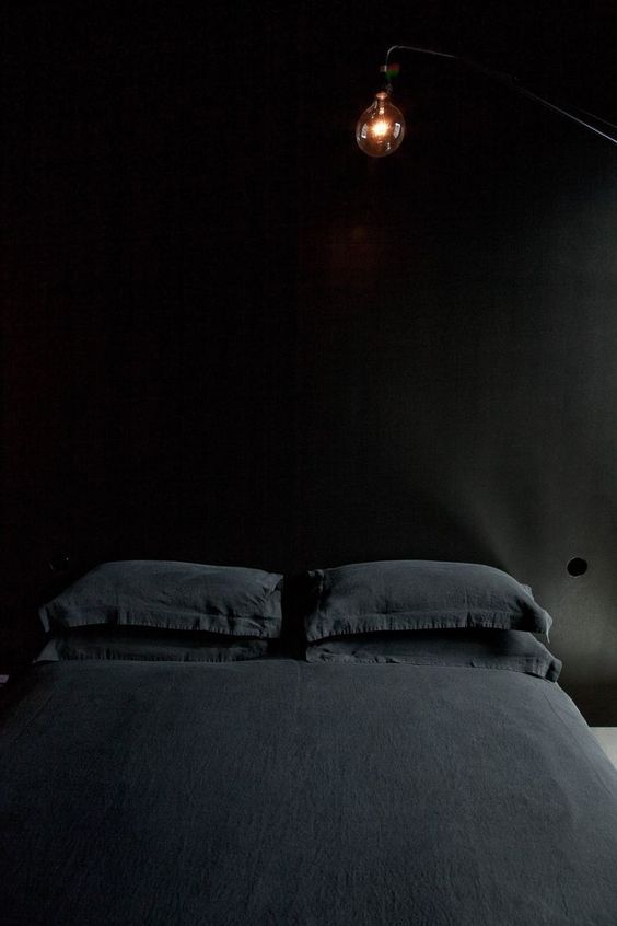 Matte black bedroom with black linen sheets. 