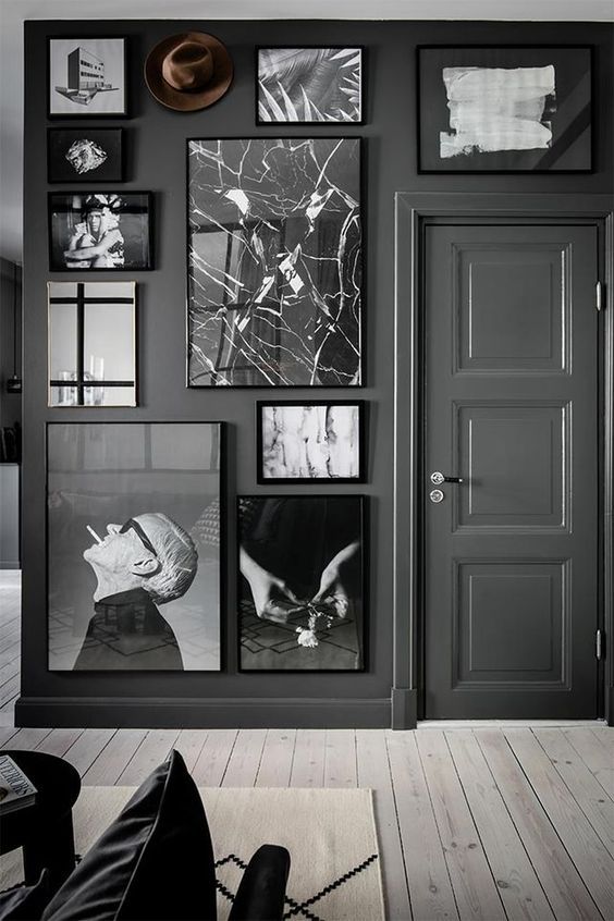 Black and white gallery wall with walls painted black. 
